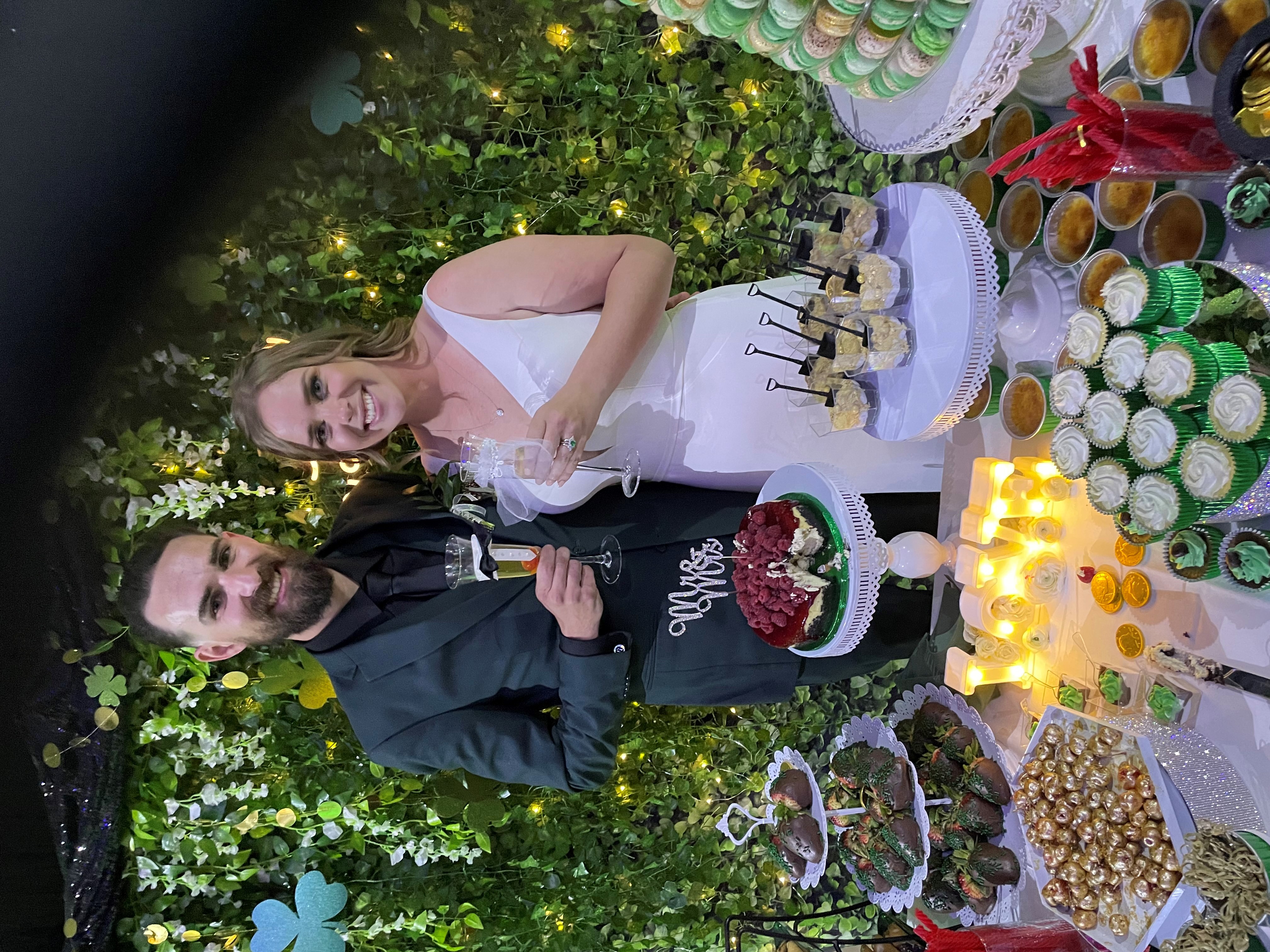 bride and groom at dessert table